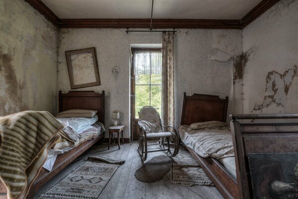 An abandoned room with two beds