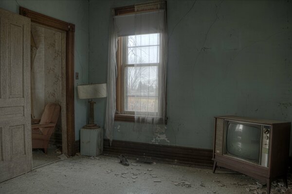 An old room with a window and a TV