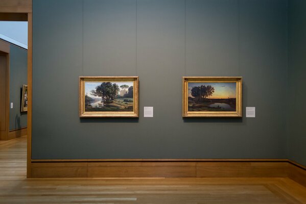 Two paintings with landscapes on the wall in the museum