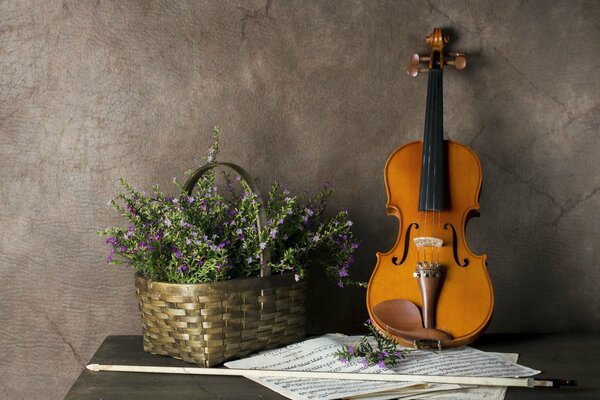 Violin with notes and a basket of flowers