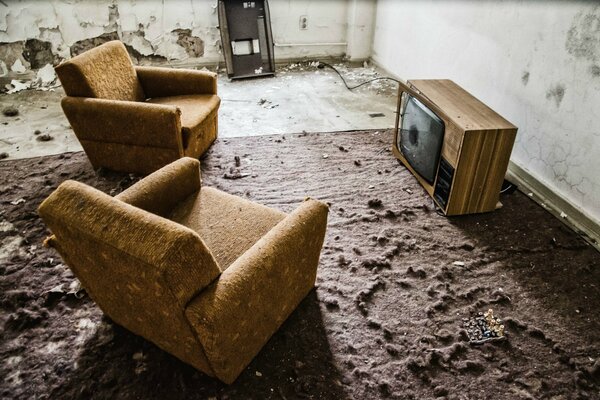 An abandoned room with a TV