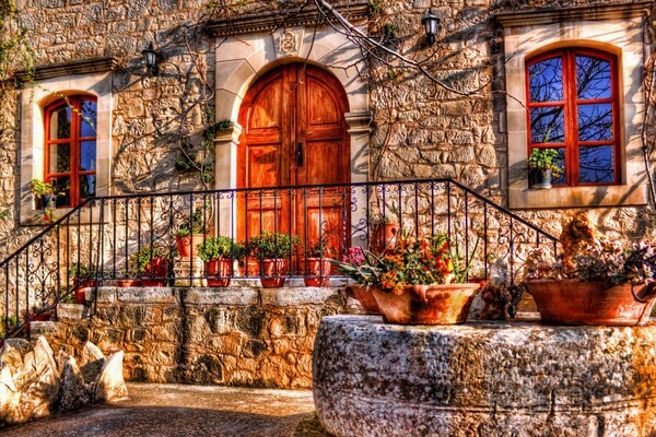 Porch of a stone house with flowers