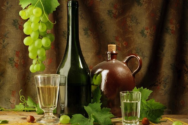 Still life with a sprig of grapes, a bottle of wine, a jug and two glasses