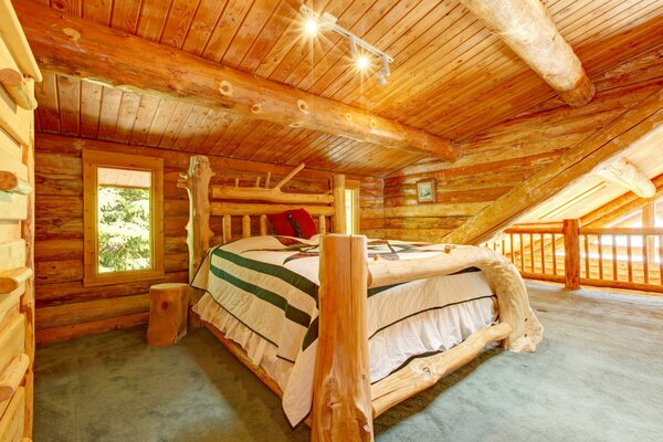 A large bed in a wooden house