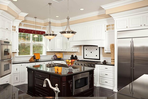 White kitchen with a black countertop with a window to the courtyard