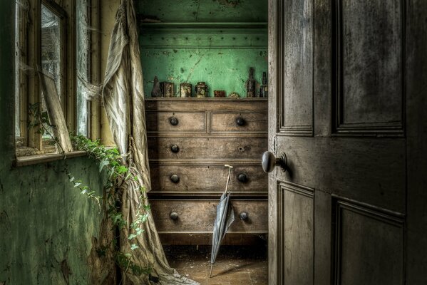 A cane at the fireplace in an abandoned house