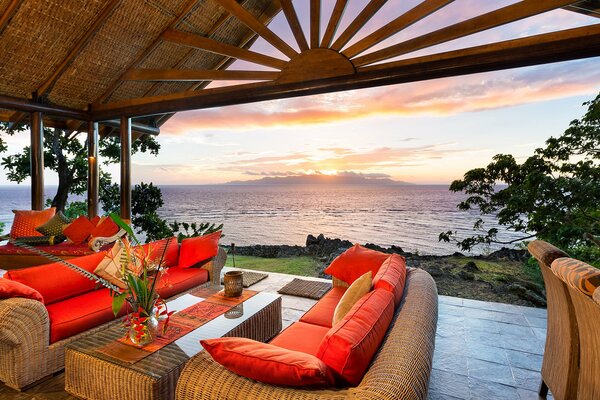 Oceanfront terrace with sofas and a table