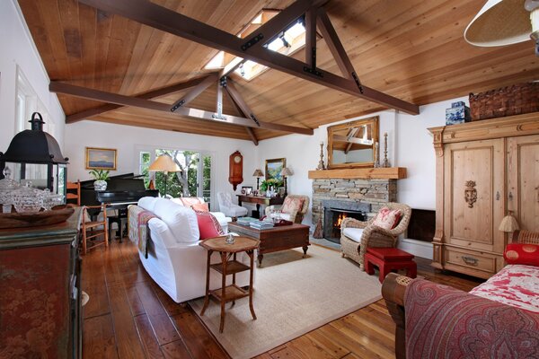 The interior of the living room with a fireplace with high ceilings