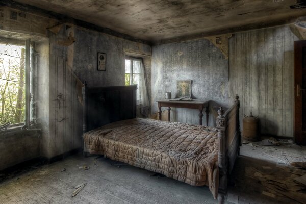 A bed in a bedroom in an abandoned house