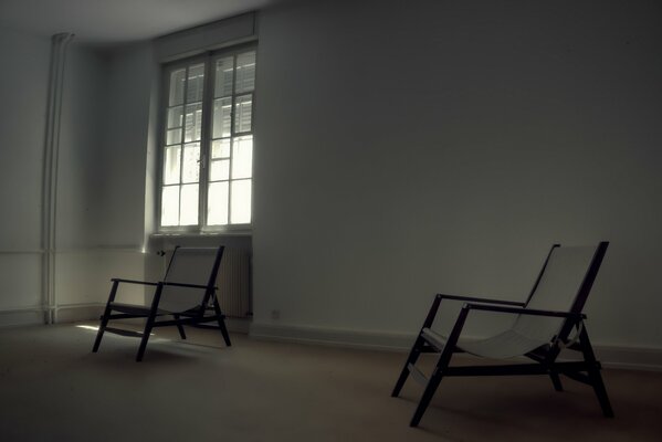 Two armchairs in an empty room