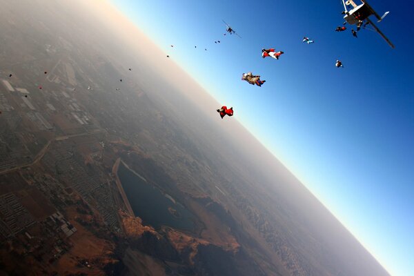 A group of parachutists jumping from an airplane