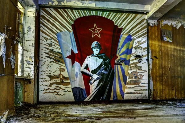 Soviet warrior on the wall of an abandoned room