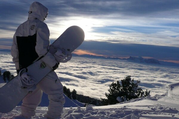 Snowboarder before jumping in snowy mountains