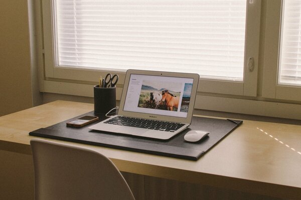 MacBook con el ratón sobre la mesa