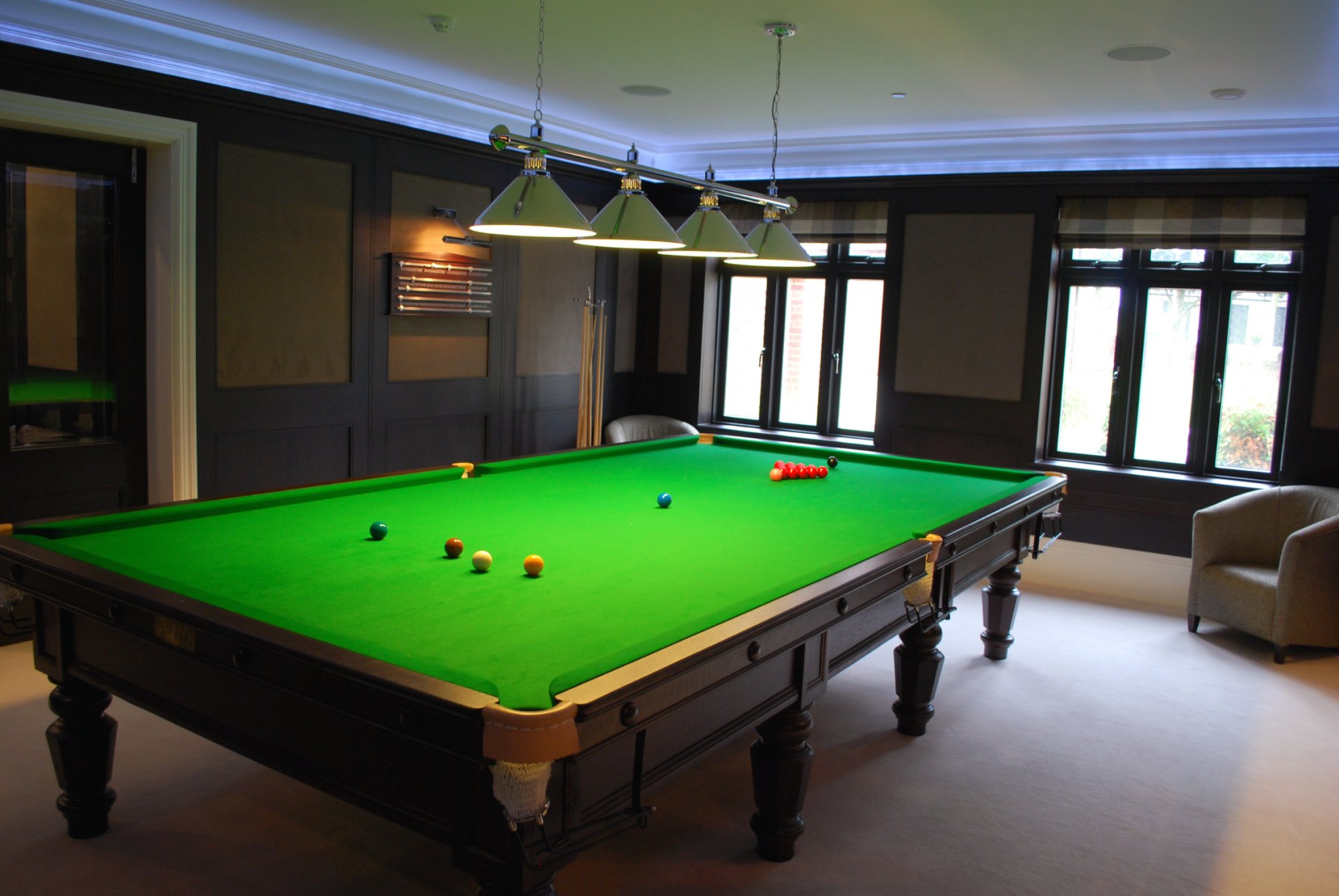 nookerroom interior pool table billiards snooker balls cues bulbs armchairs lighting