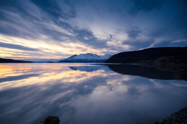 Reflection of mountains and blue sky in water