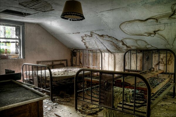 An abandoned house with metal beds