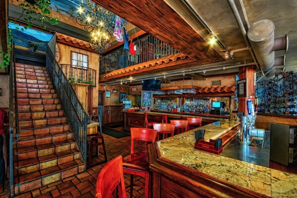 Photo of the interior of a bar with a staircase