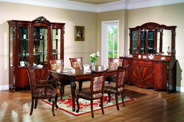 Room with table, chairs, sideboard and carpet