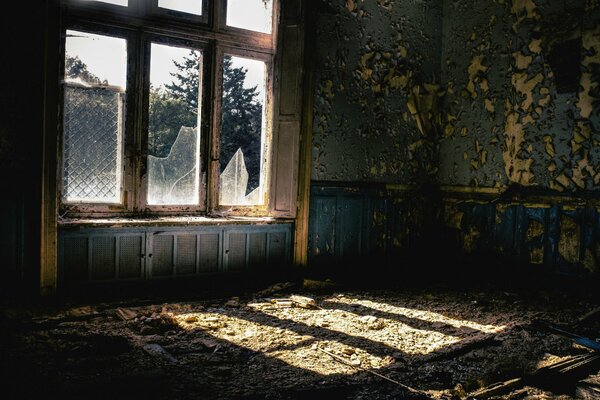 Abandoned house with broken glass in the window view from the inside