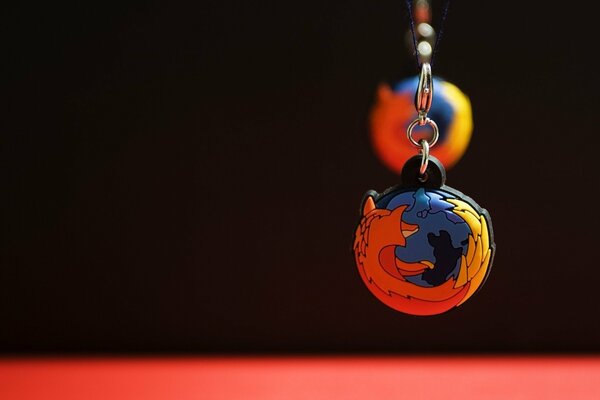 Keychain fiery red fox on the ball