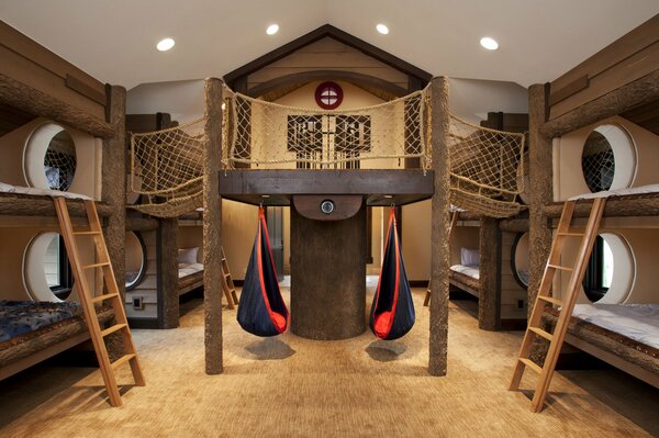 A game-style room with bunk beds with stairs