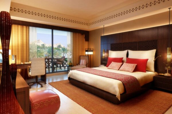 The interior of the bedroom is equipped with a large bed, soft pillows and a beautiful view from the window