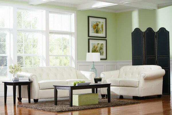 Green walls, white sofas and a large window