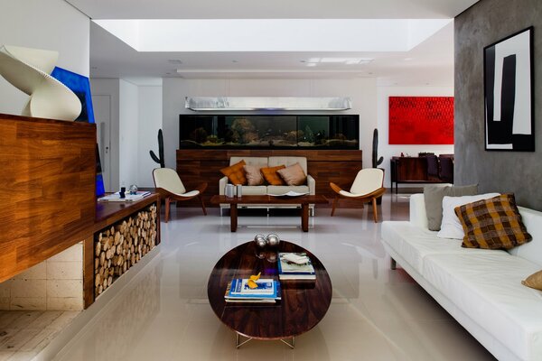 Interior of a room with a sofa, an armchair and an aquarium