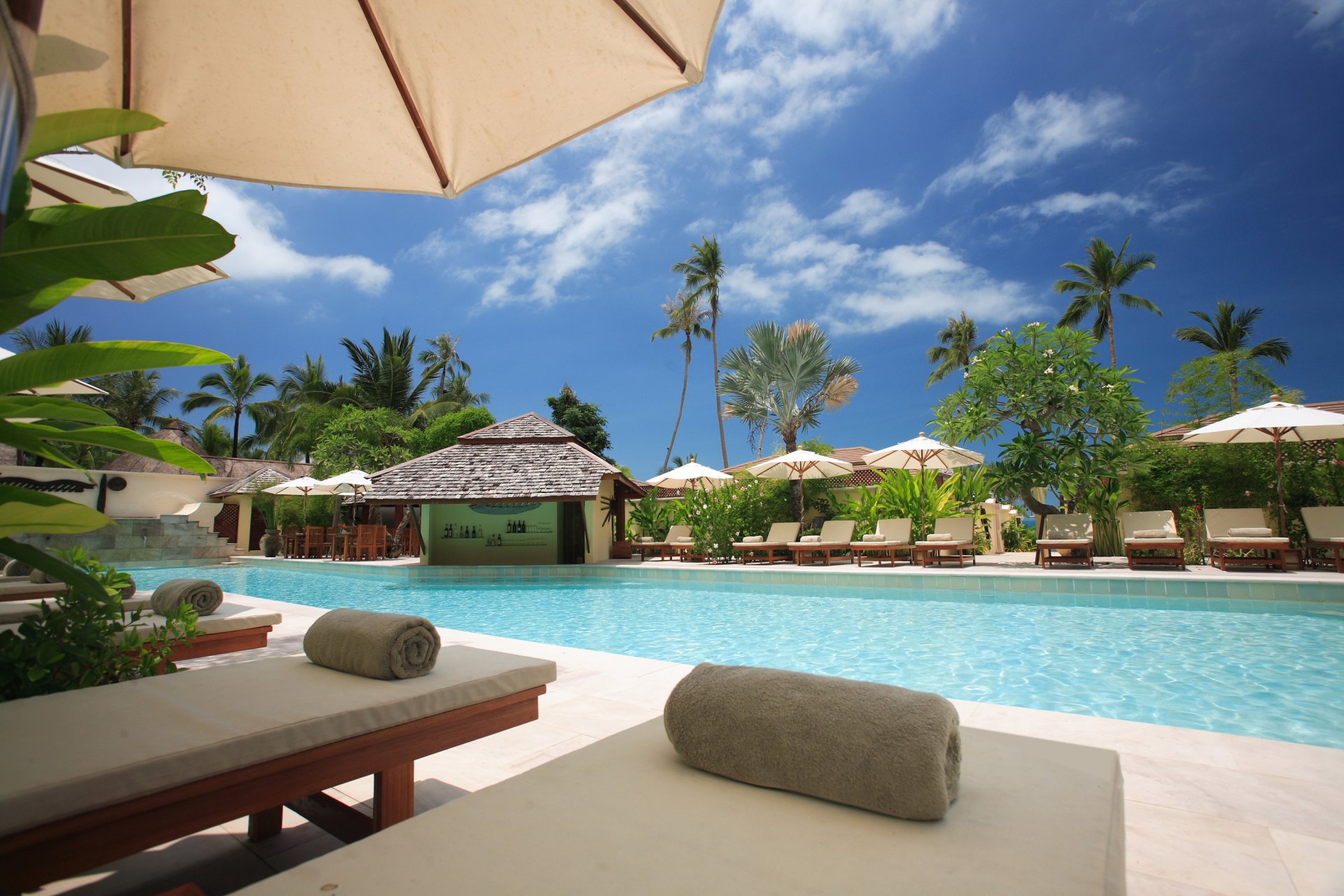 amui resort pool bar islands hotel beds chairs palm tree exterior