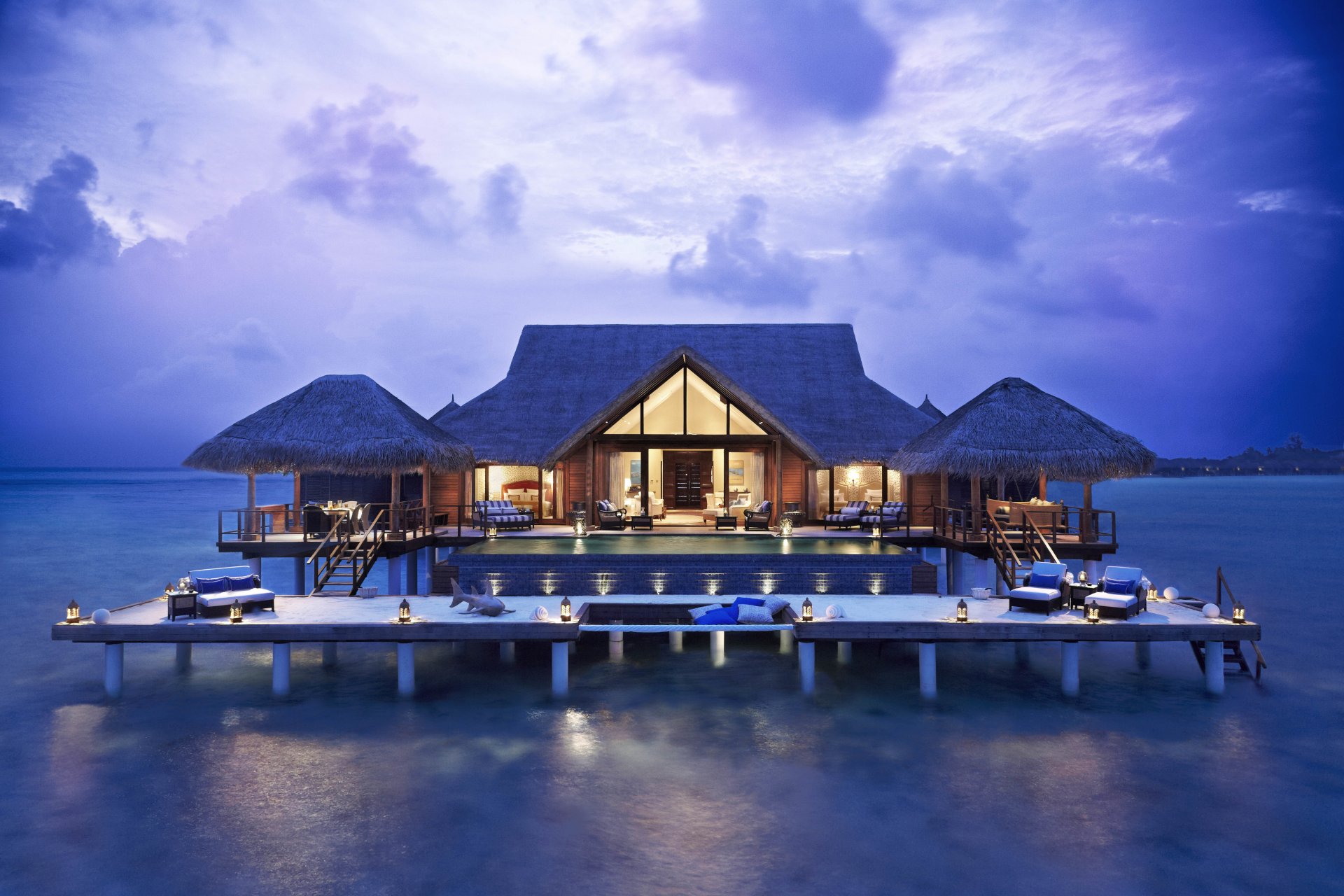 home pool house of the pile bedroom dining armchairs sofas lamps sea water clouds sky evening