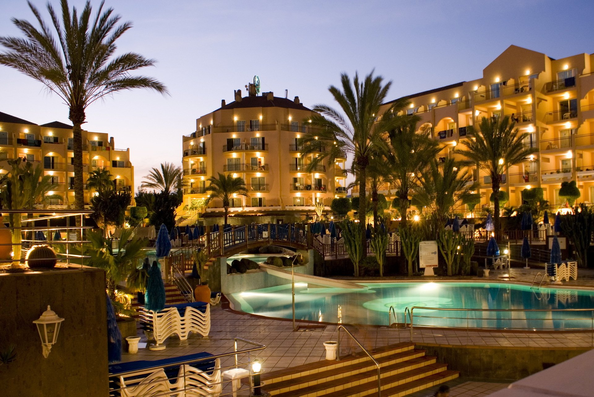 hotel resort spain spain swimming pools swimming pool bridge architecture palm trees evening