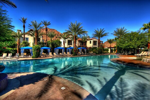 Multi-room villa with swimming pool and palm trees