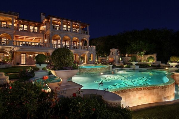 A house in the night and a pool with lighting