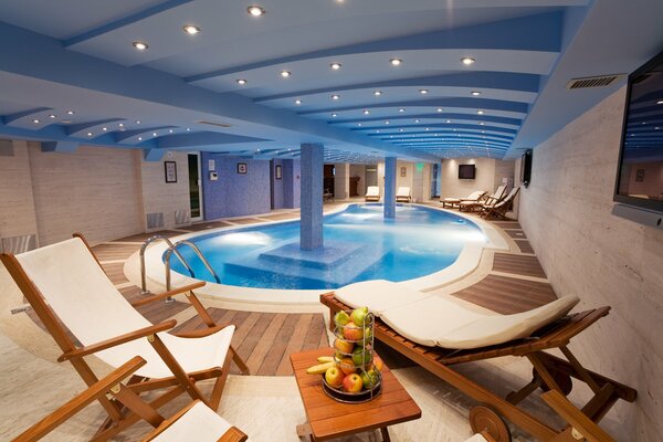 Beautiful interior with swimming pool and sun loungers