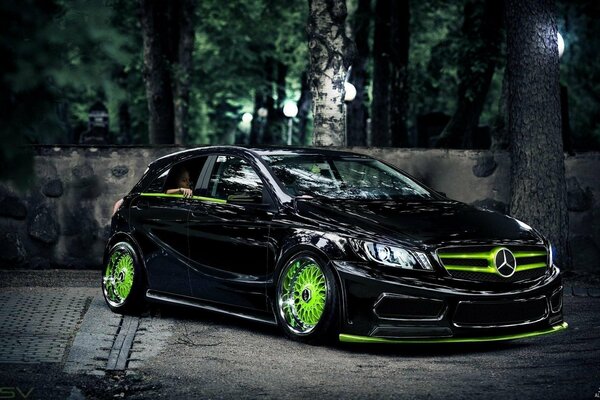 A beautiful car with green wheels