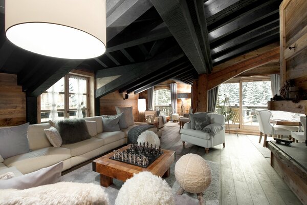 Stylish interior of the living room in a country house with a large white sofa