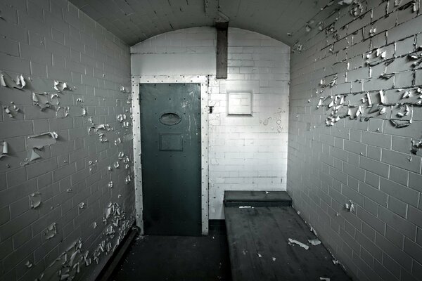 An old prison cell with a sunbed