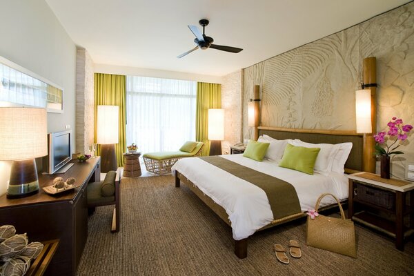 Large bed in the bedroom with green pillows