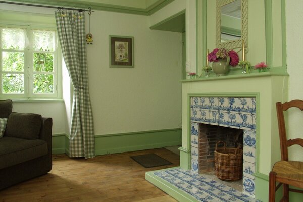 Green cozy room with fireplace