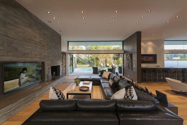 Huge living room in a modern style with leather sofas and access to the pool