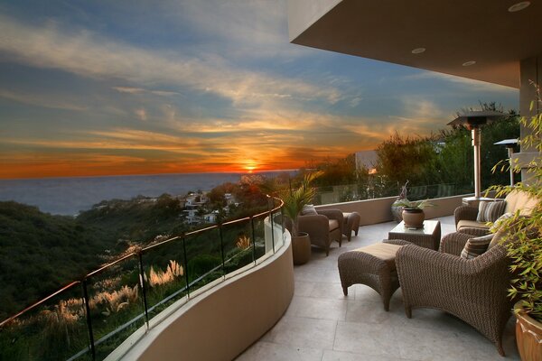 Terrace with wicker chairs at sunset