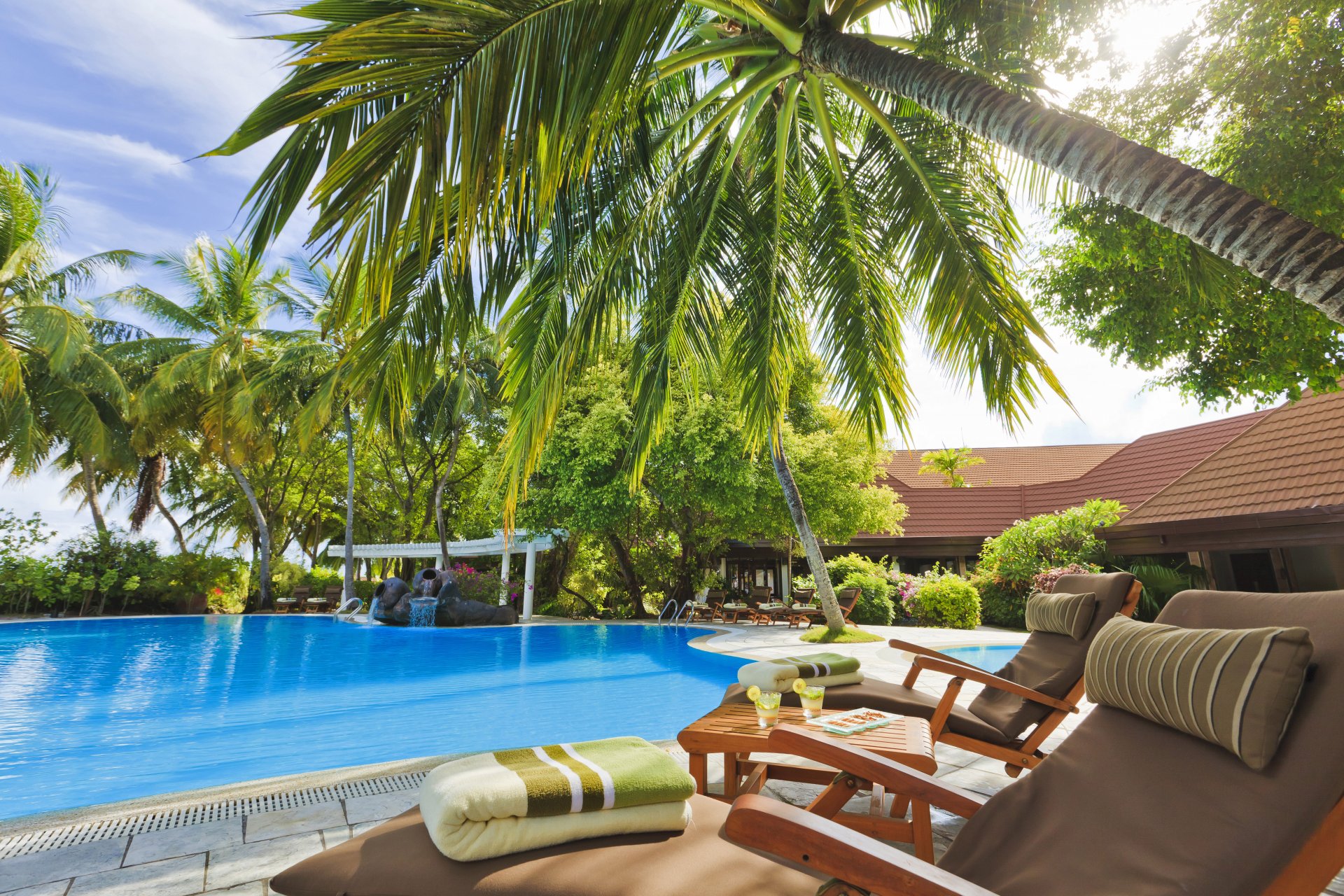 pool hotel the maldives exterior chairs table palm tree