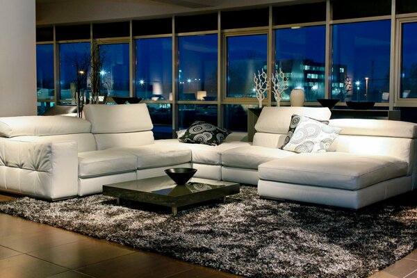 Contrast of a white sofa and a black table in the room