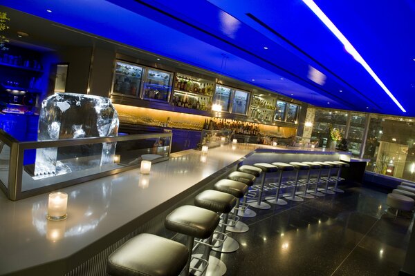 Bar counter with illuminated chairs