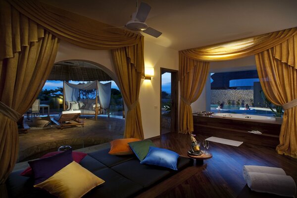 The interior of a chic bathroom with a Jacuzzi and large windows