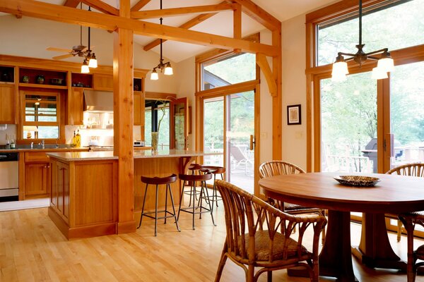 The interior of the kitchen and dining room is decorated with wood