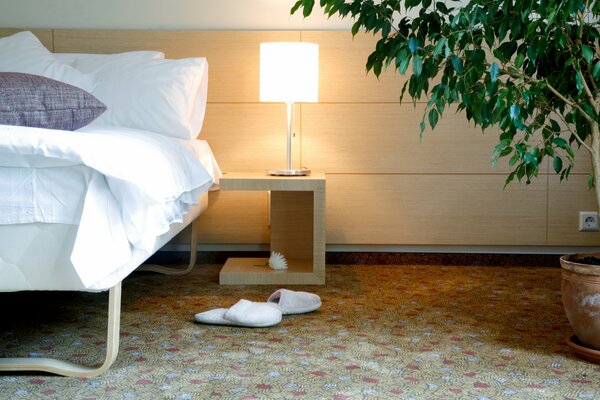 Bed with bedside table lighting in the bedroom