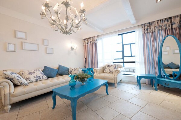 A bright room with a blue table and a blue mirror