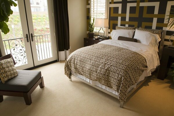 Cozy interior of a bedroom with a balcony